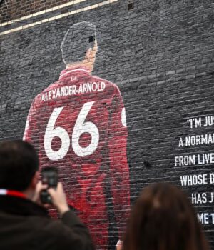 Fans-of-Liverpool-take-a-picture-of-a-mural-which-features-Trent-Alexander-Arnold.jpeg