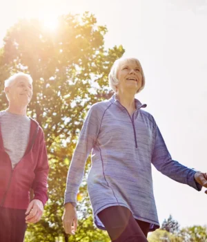 smiling-senior-couple-walking-in-sun.webp.webp
