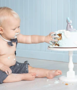 messy-baby-boy-smashing-his-birthday-cake.webp.webp