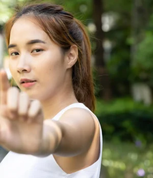 young-asian-woman-practicing-traditional-chinese-baduanjin-kungfu-qigong-martial-arts-in-park.webp