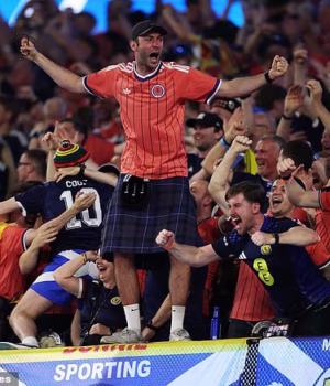 109336215-15898561-Scotland_fans_celebrate_after_John_McGinn_s_deflected_effort_gav-a-2_178142501963.avif