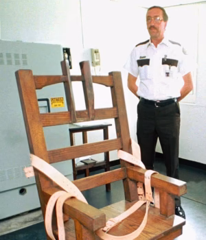 109753831-15948495-A_Florida_State_Prison_guard_pictured_next_to_Old_Sparky_the_sta-a-2_178301770268.avif