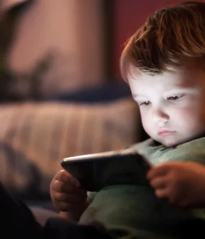 cute-boy-staring-at-cell-phone-screen.webp