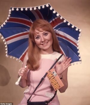 111036761-16103265-Lulu_modelling_the_Union_Jack_umbrella_back_in_1969-a-58_1788458719212.jpg