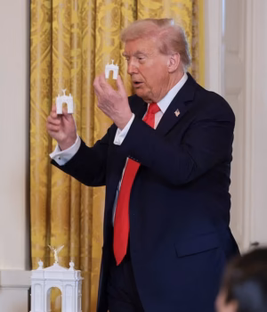 111358303-16146099-US_President_Donald_Trump_holds_models_of_an_arc_monument_during-a-19_17899104314.avif