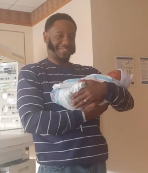 111365245-16146525-Michael_Desronvil_48_was_seen_holding_his_newborn_daughter_in_a_-a-12_17899459394.avif
