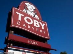 Sem peso! Fury enquanto o chef Toby Carvery é filmado pesando cuidadosamente um pedaço de carne que está servindo.