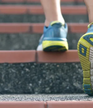 man-with-athletic-shoes-walking-up-stairs.webp