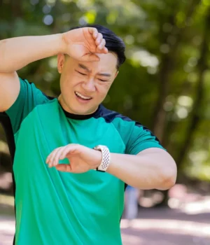tired-asian-man-fitness-running-exercise-looking-at-watch.webp